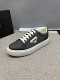 Prada Triangle Patch Low-Top Sneakers — hero