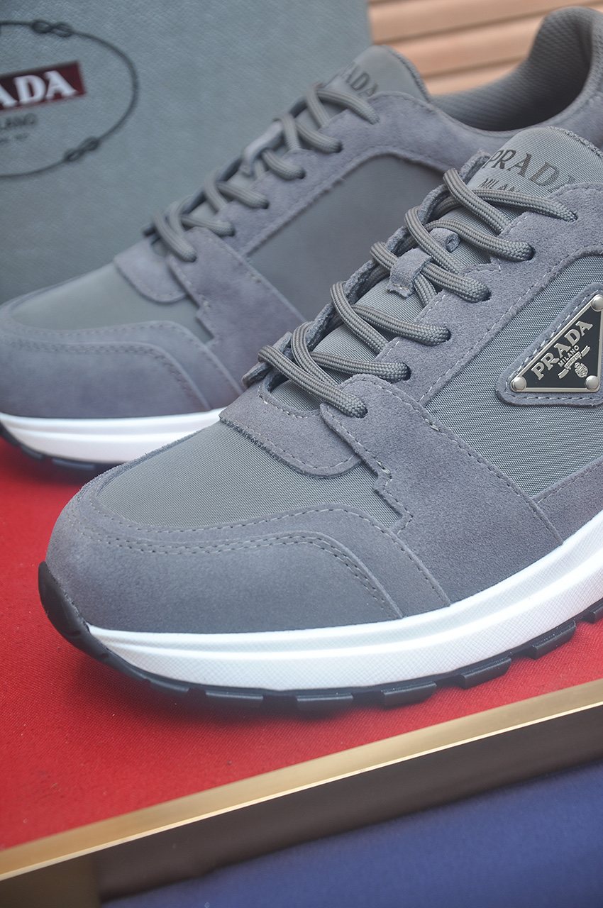 Prada Triangle Plaque Low-Top Sneakers — detail