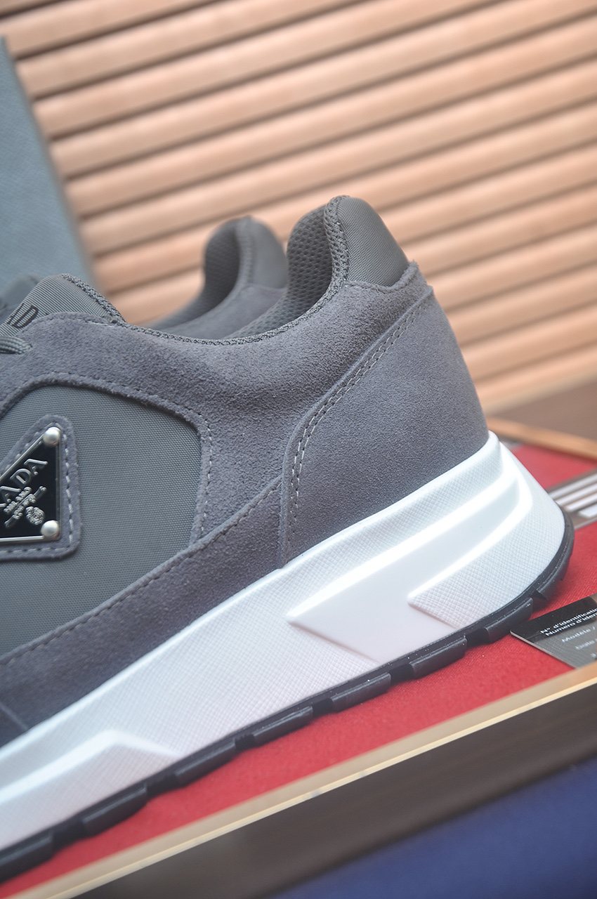 Prada Triangle Plaque Low-Top Sneakers — detail