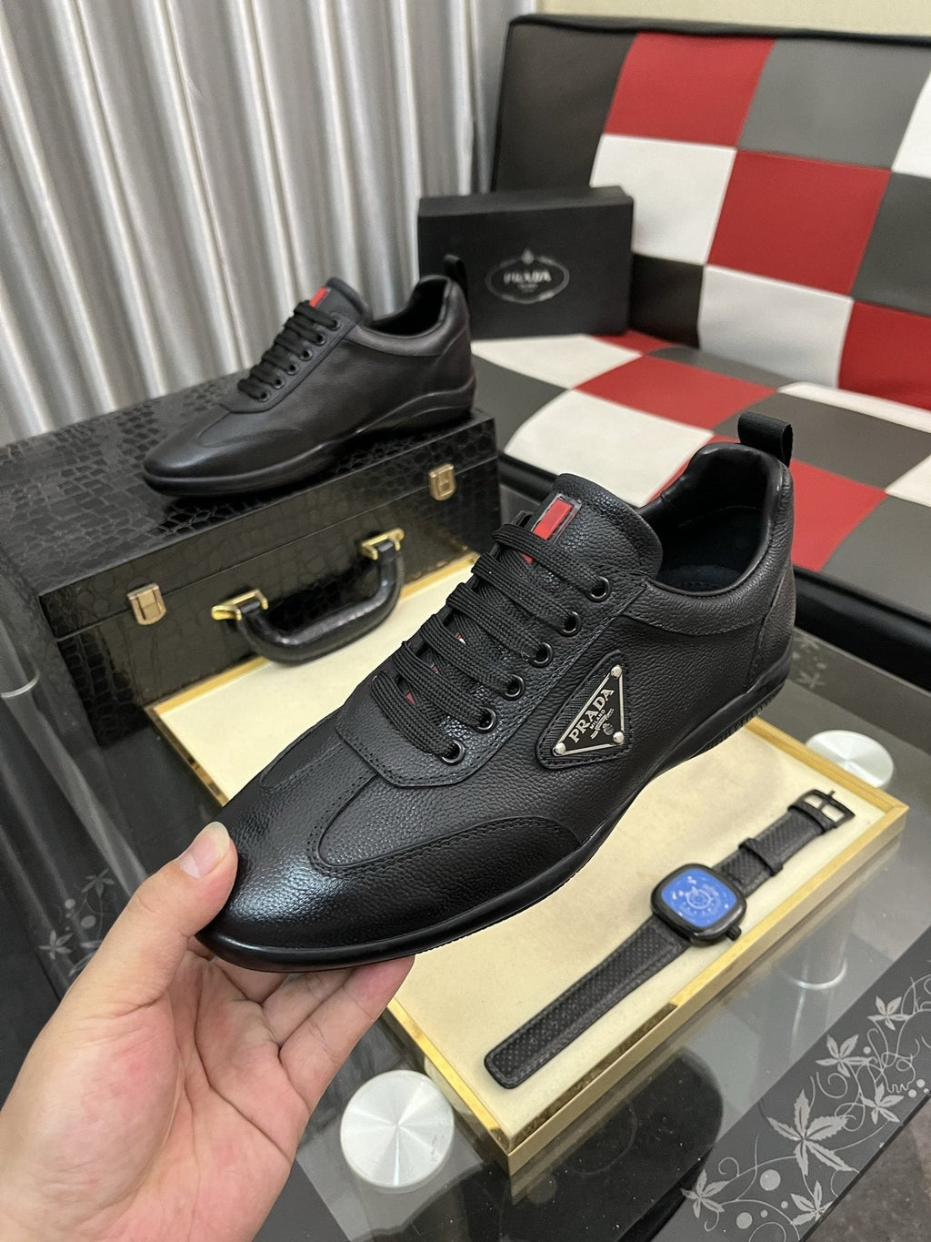 Prada Black Lace-Up Sneakers with Red Tab — model