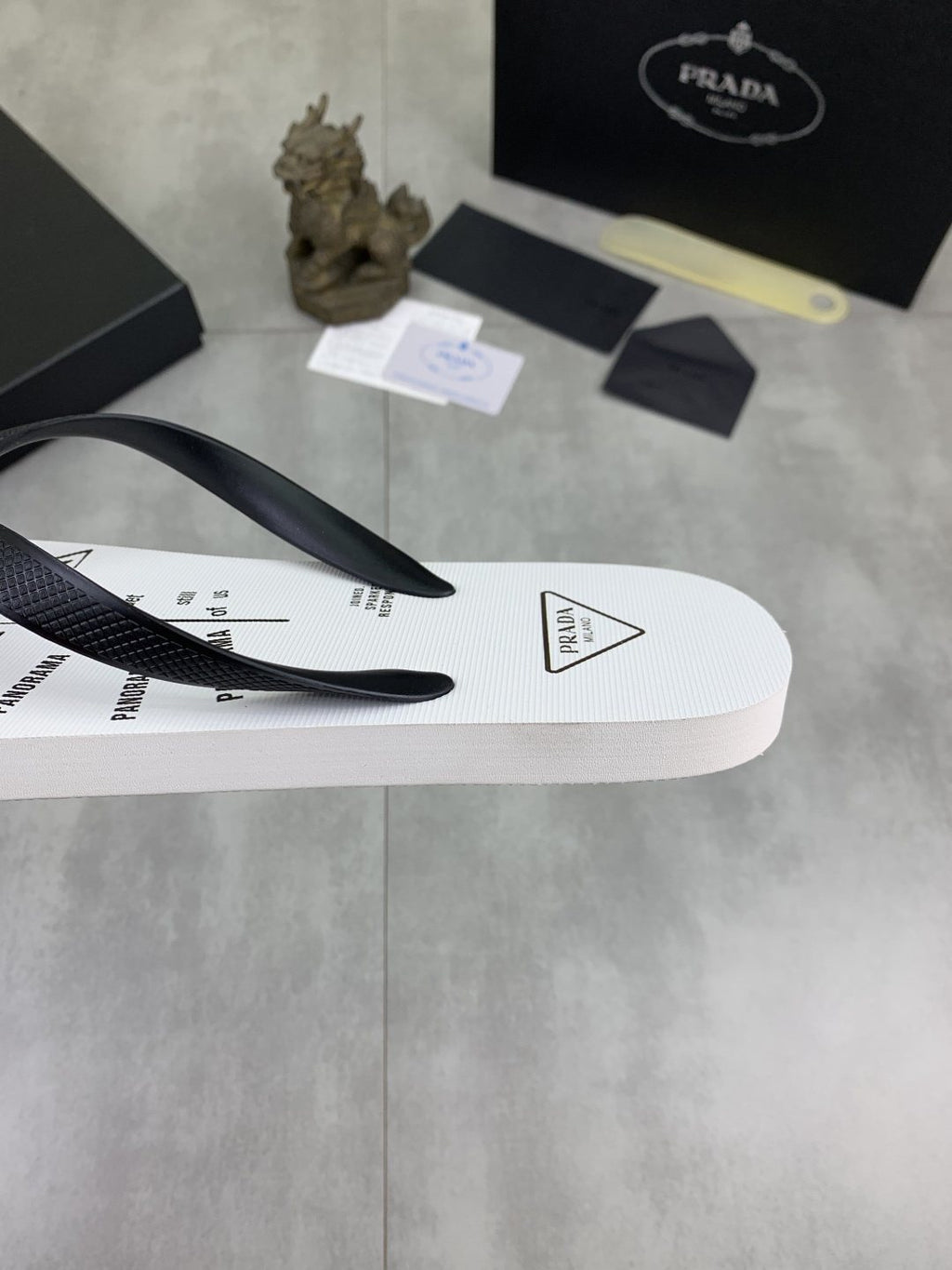 Prada Black Strap White Flip Flops — detail