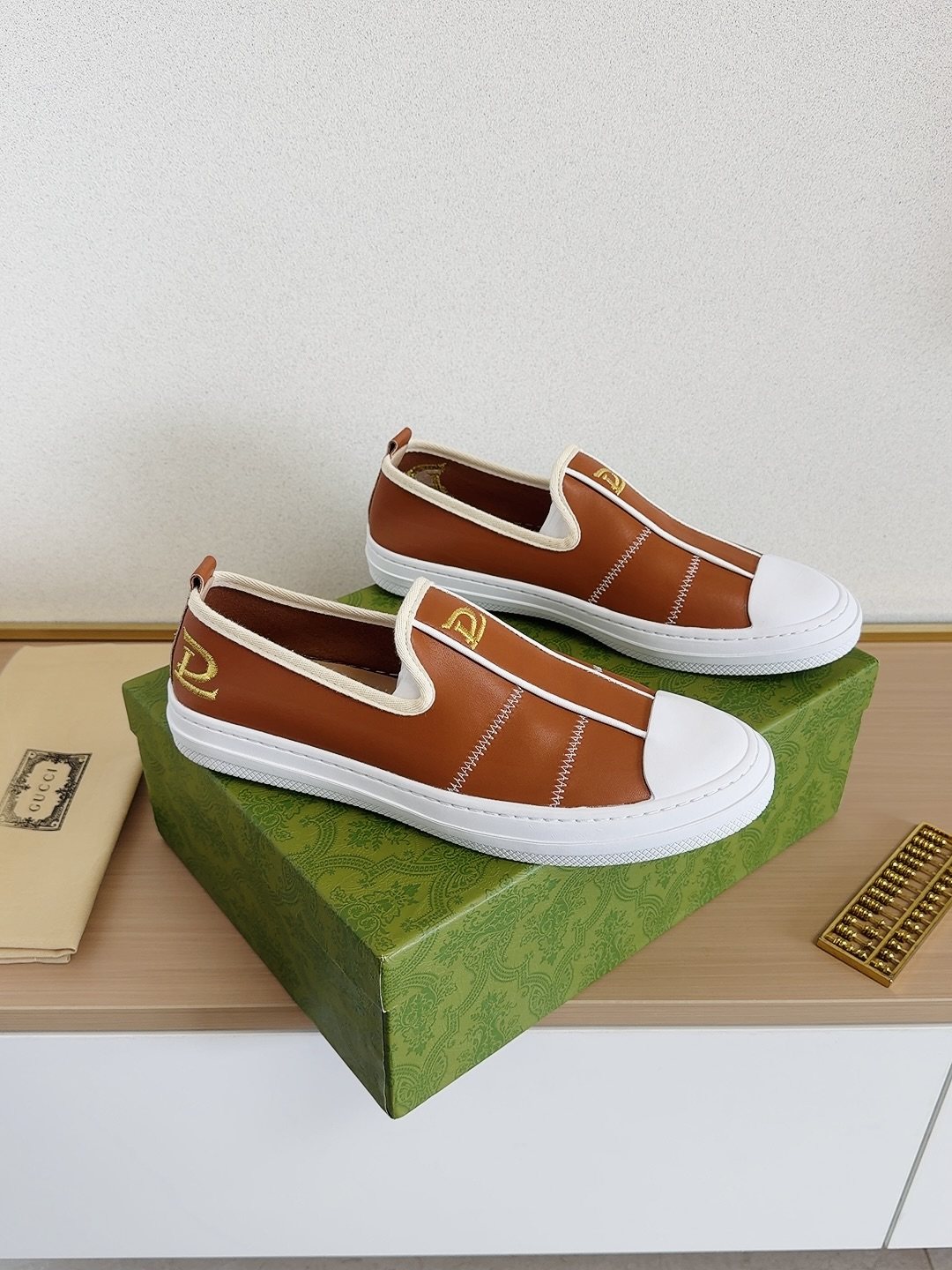 Gucci Brown Slip-On Sneakers with White Toe Caps — front